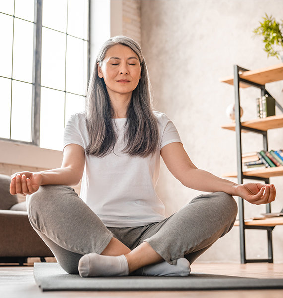 Woman meditating in living room